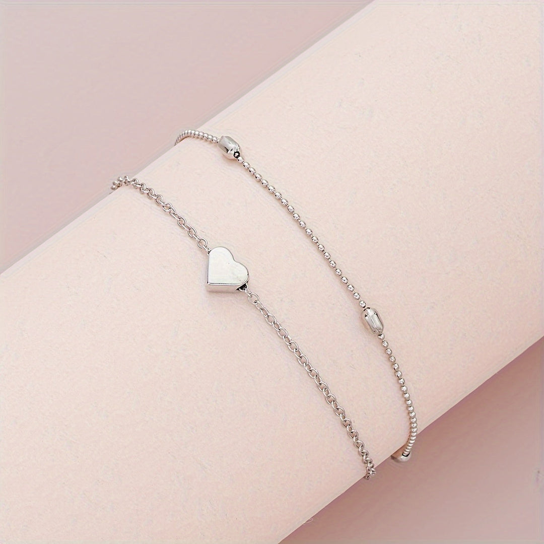 Conjunto de joyería con corazón y perlas en capas