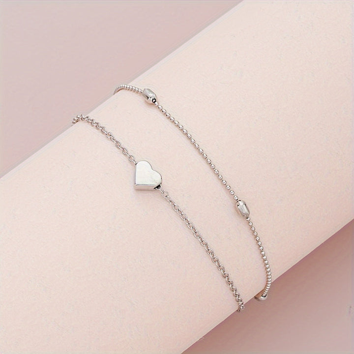 Conjunto de joyería con corazón y perlas en capas