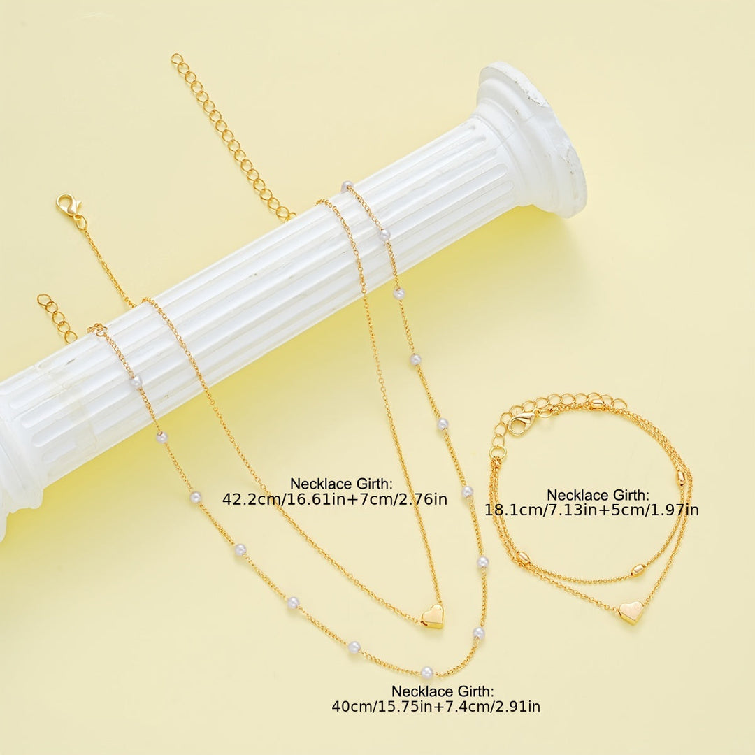 Conjunto de joyería con corazón y perlas en capas