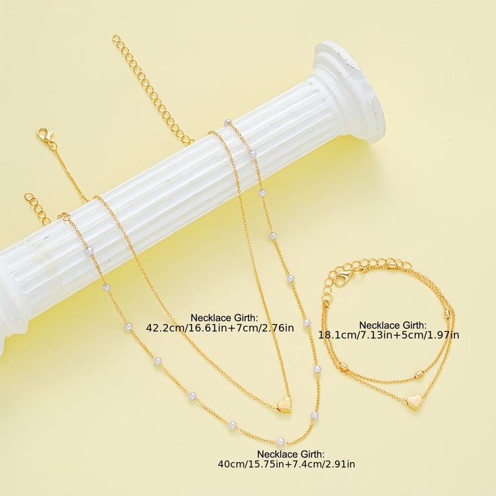 Conjunto de joyería con corazón y perlas en capas