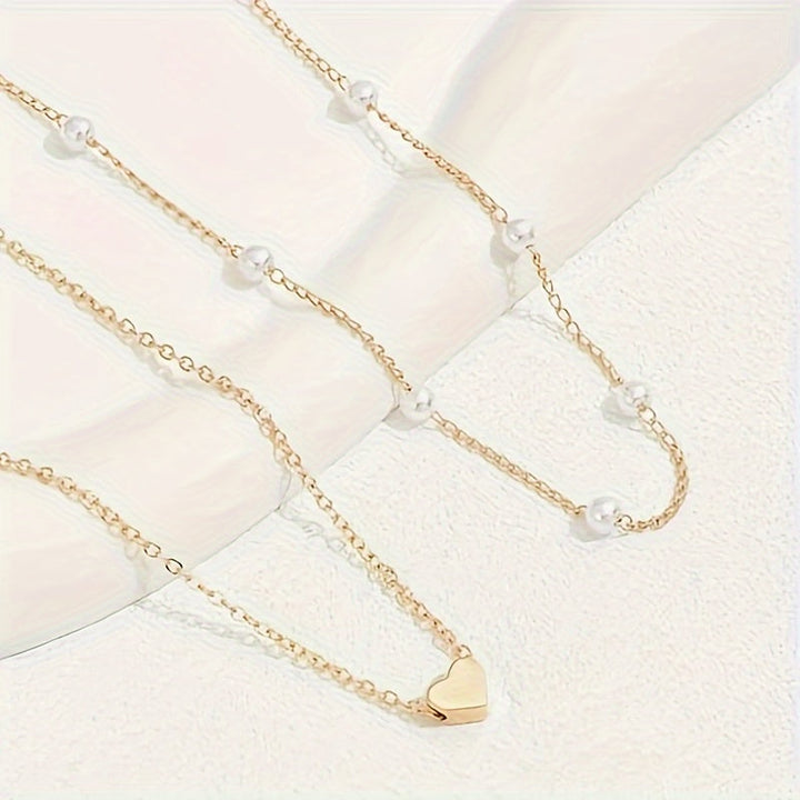 Conjunto de joyería con corazón y perlas en capas